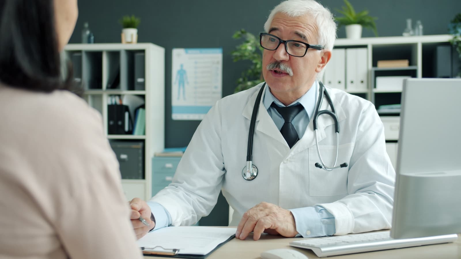 A doctor talking with a patient during a consultation